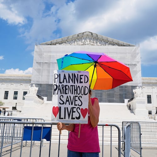 FILE - A protester stands outside of the Supreme Court, June 26, 2025, in Washington. (AP Photo/Mariam Zuhaib, File)