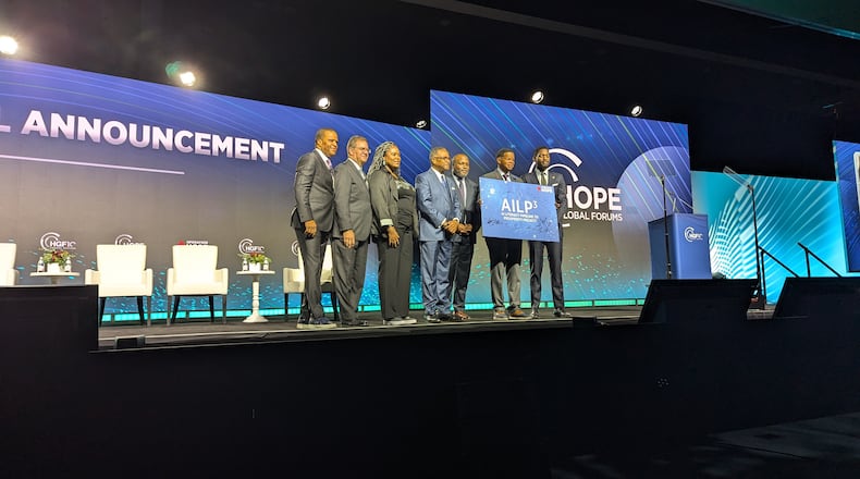 Atlanta leaders sign an agreement to establish the AI Literacy Pipeline to Prosperity Project for students from underserved communities on Wednesday, Dec. 11, 2024, in Atlanta.
From left to right: John Hope Bryant, CEO of Operation HOPE; Richard Phillips, dean of Georgia State University's J. Mack Robinson College of Business; Erika Mitchell, chair of the Atlanta Board of Education; George French, president of Clark Atlanta University; Bryan Johnson, superintendent of Atlanta Public Schools; Lance Triggs, Operation HOPE president of operations; and a representative from Mayor Andre Dickens' office.