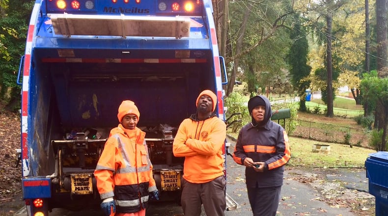 The economy has been adding jobs across a wide swath, from corporate to blue collar. Here, Michael Swift, a driver in Atlanta’s solid waste department, center, on the route with laborers Nichole White, left, and Tymeko Mack, right. (Photo by Bill Torpy)