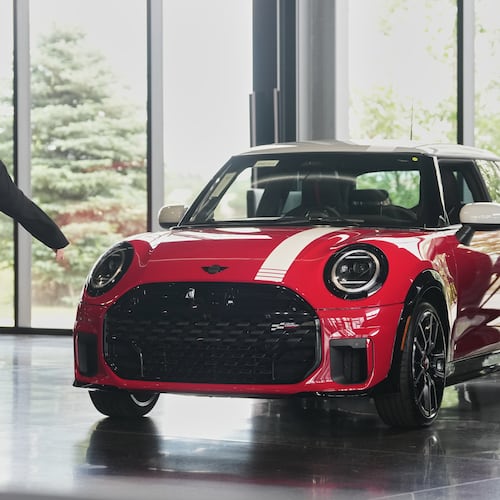 FILE - A shopper passes by an unsold 2026 Cooper S John Cooper Works 1965 Victory Edition hardtop on display in the showroom of a Mini dealership Friday, June 26, 2026, in Highlands Ranch, Colo. (AP Photo/David Zalubowski, File)