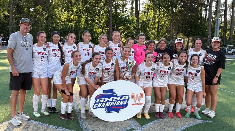 Pike County players and coaches celebrate after winning their second consecutive Class 2A girls soccer championship on May 13, 2026, at St. Pius X High School in Atlanta. (Chip Saye/AJC)