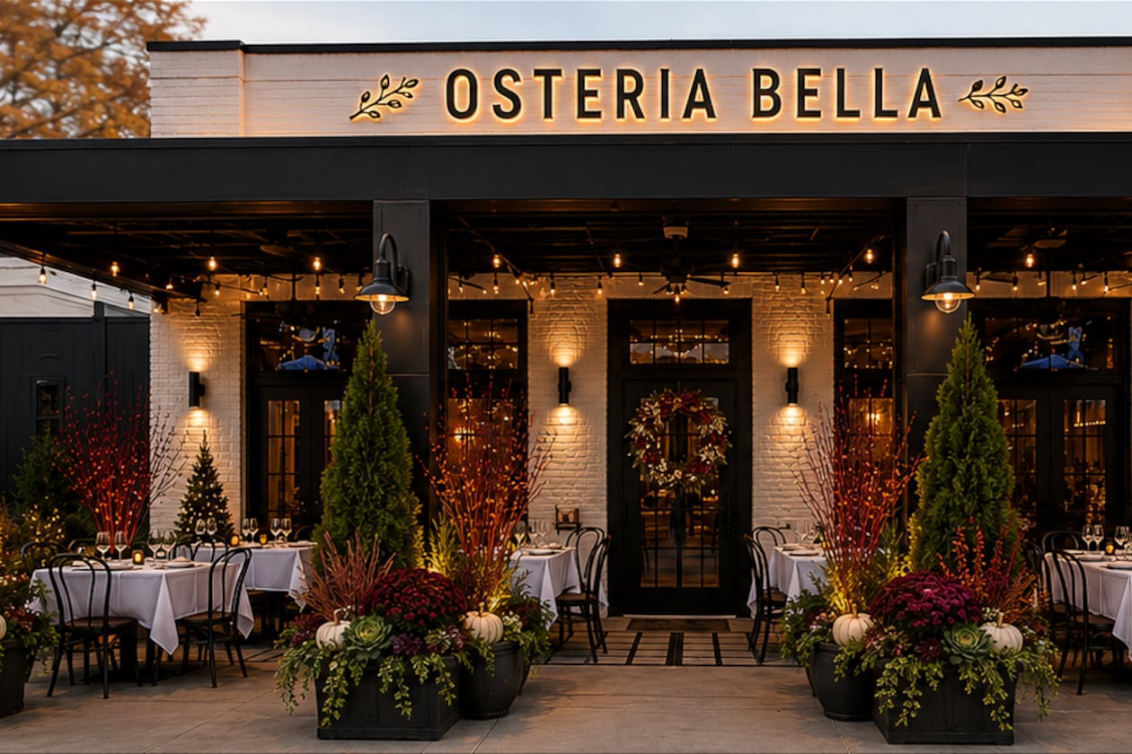The exterior of a modern Italian restaurant called Osteria Bella at dusk.