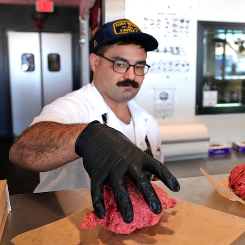 Nate Abeyta, owner and founder of Deep Cuts butcher shop prepares an order of ground meat for a customer, Tuesday, Oct. 21, 2025, in Dallas. (AP Photo/Tony Gutierrez)