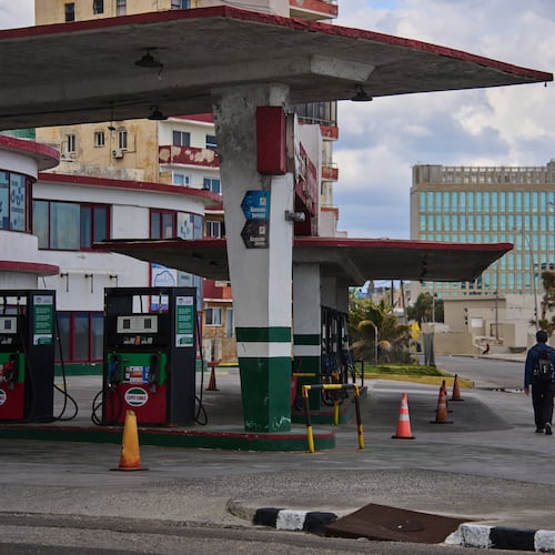 FILE - A man walks past a gas station that has run out of fuel, located near the U.S Embassy, pictured in the background, in Havana, Cuba, Feb. 7, 2026. (AP Photo/Ramon Espinosa, File)