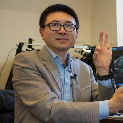 Xuanhe Zhao, professor of mechanical engineering at the Massachusetts Institute of Technology, poses for a portrait with an ultrasound wristband that can help a robotic hand mimic full hand motions in Cambridge, Mass, on Tuesday, April 14, 2026. (AP Photo/Rodrique Ngowi)