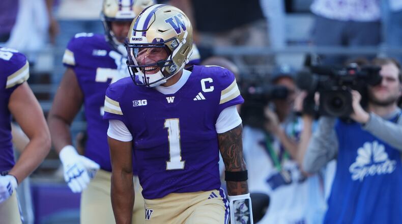Washington quarterback Demond Williams Jr. celebrates scoring a touchdown against Washington State during the first half of an NCAA college football game, Sunday, Sept. 6, 2026, in Seattle. (AP Photo/Lindsey Wasson)