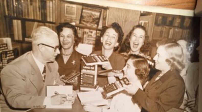 Ray Sprigle, a white journalist who went undercover as a black man in 1948 signs copies of his book. Photo credit: Senator John Heinz History Center