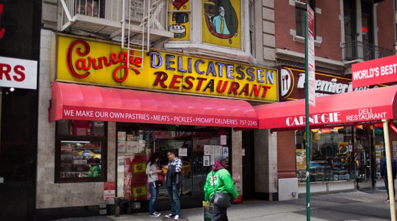 NEW YORK, NY - APRIL 28: People pass the Carnegie Delicatessen in Manhattan after it was shut down over an investigation into tampering with natural gas lines April 28, 2015 in New York City. The landmark deli was closed after Con Ed inspectors discovered evidence that the iconic restaurant had illegally tampered with its gas hookup. (Photo by Kevin Hagen/Getty Images)