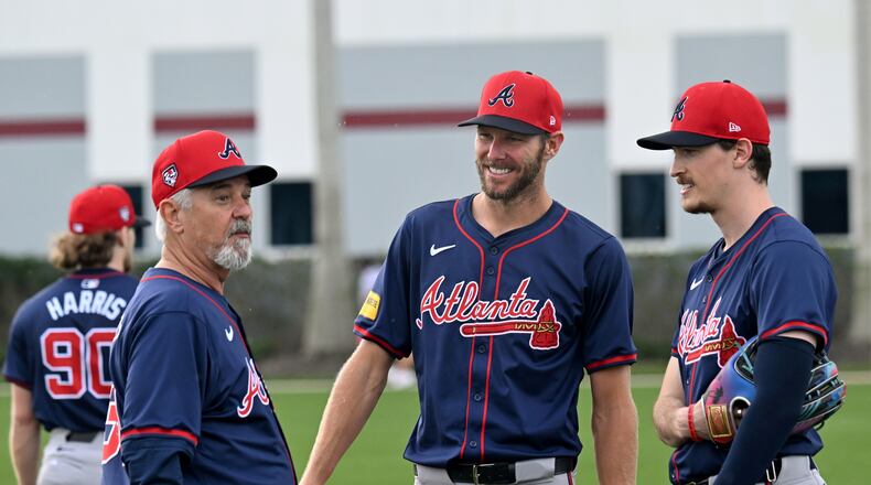 Atlanta Braves starting pitcher Chris Sale (center) and  starting pitcher Max Fried (right) smile as they talk with pitching coach Rick Kranitz during spring training workouts at CoolToday Park, Saturday, February, 17, 2024, in North Port, Florida. (Hyosub Shin / Hyosub.Shin@ajc.com)
