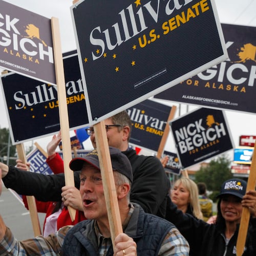 Sen. Dan Sullivan, R-Alaska, who is seeking a third term, flashes a thumbs up after a passing motorist honked during a sign waving event at an intersection on primary election day in Anchorage, Alaska, Tuesday, Aug. 18, 2026. (AP Photo/Mark Thiessen)
