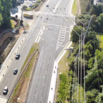 An aerial image of a stretch of Pleasant Hill Road through Duluth. Portman Holdings is pursuing plans to turn nearly 112 acres of forested land in Duluth into a mixed-use community. (Courtesy Gwinnett County via Dji)