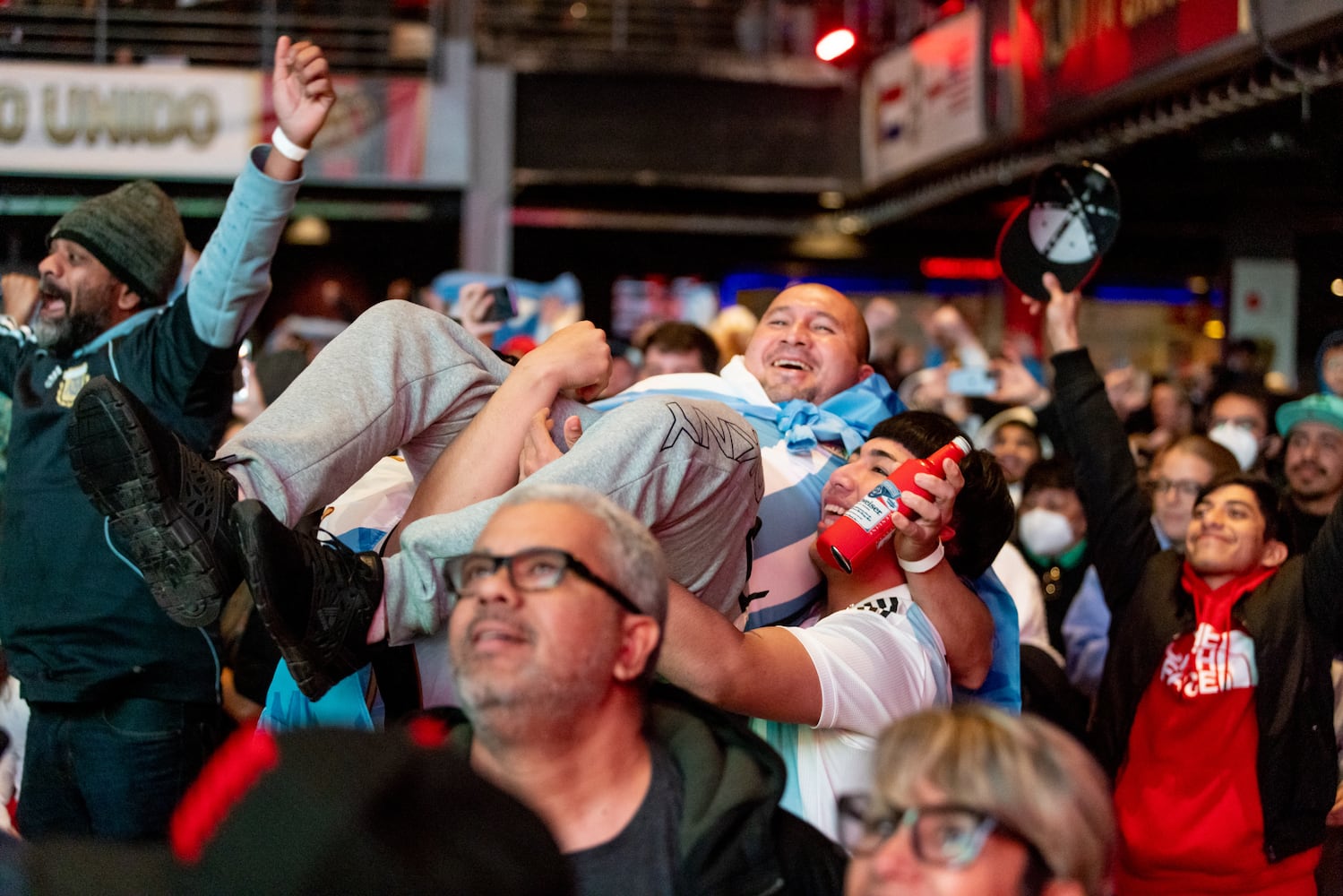 A fan is carried by his friends during a World Cup watch party at the Roxy in Atlanta, on Sunday, December 18, 2022. (Photo/Jenn Finch)