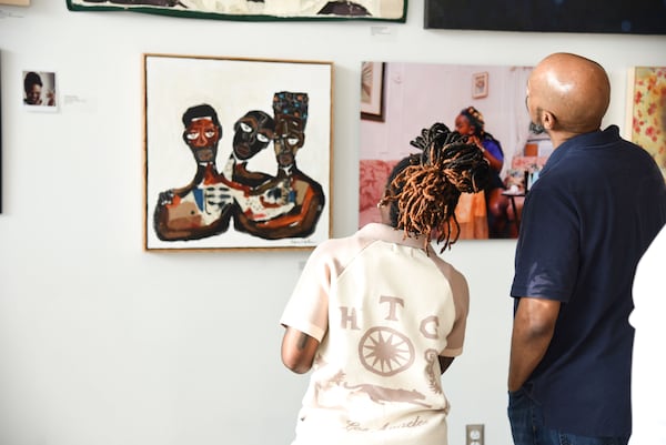Guests check out the "We Need Love" exhibit at the African Diaspora Art Museum of Atlanta, located in the Nia Building at Pittsburgh Yards. (Photo by Ty Peas)