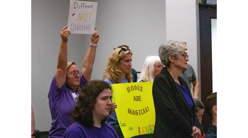 Demonstrators Andrea Kramer and Kristin Thomas hold up signs to urge the Cobb County school board to embrace inclusivity following a teacher’s impending termination regarding a book that was read to her fifth grade class in Marietta on Thursday, July 20, 2023. (Katelyn Myrick/katelyn.myrick@ajc.com)