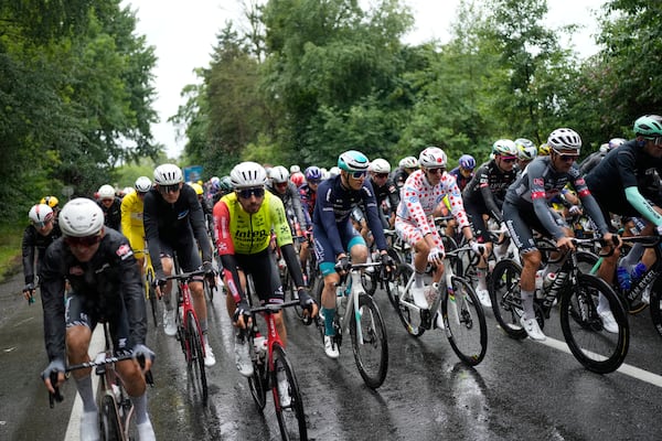 The pack with Slovenia's Tadej Pogacar wearing the best climber's dotted jersey rides during the third stage of the Tour de France cycling race over 178.3 kilometers (110.8 miles) with start in Valenciennes and finish in Dunkerque, France, Monday, July 7, 2025. (AP Photo/Mosa'ab Elshamy)