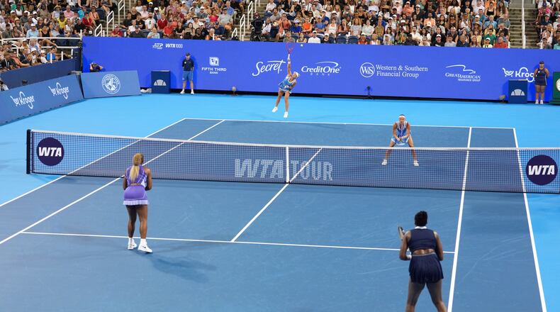 As Peyton Stearns, top right, of the United States, looks on, Marta Kostyuk, top center, of Ukraine, serves against Serena Williams, bottom left, and Venus Williams, bottom right, also of the United States, during a women's doubles match at the Cincinnati Open tennis tournament, Monday, Aug. 17, 2026, in Mason, Ohio. (AP Photo/Kareem Elgazzar)