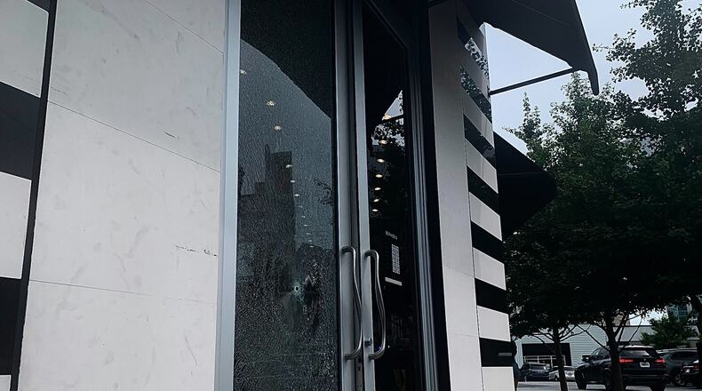 A man is in custody after a stray bullet shattered the front door of a Buckhead storefront Tuesday afternoon.