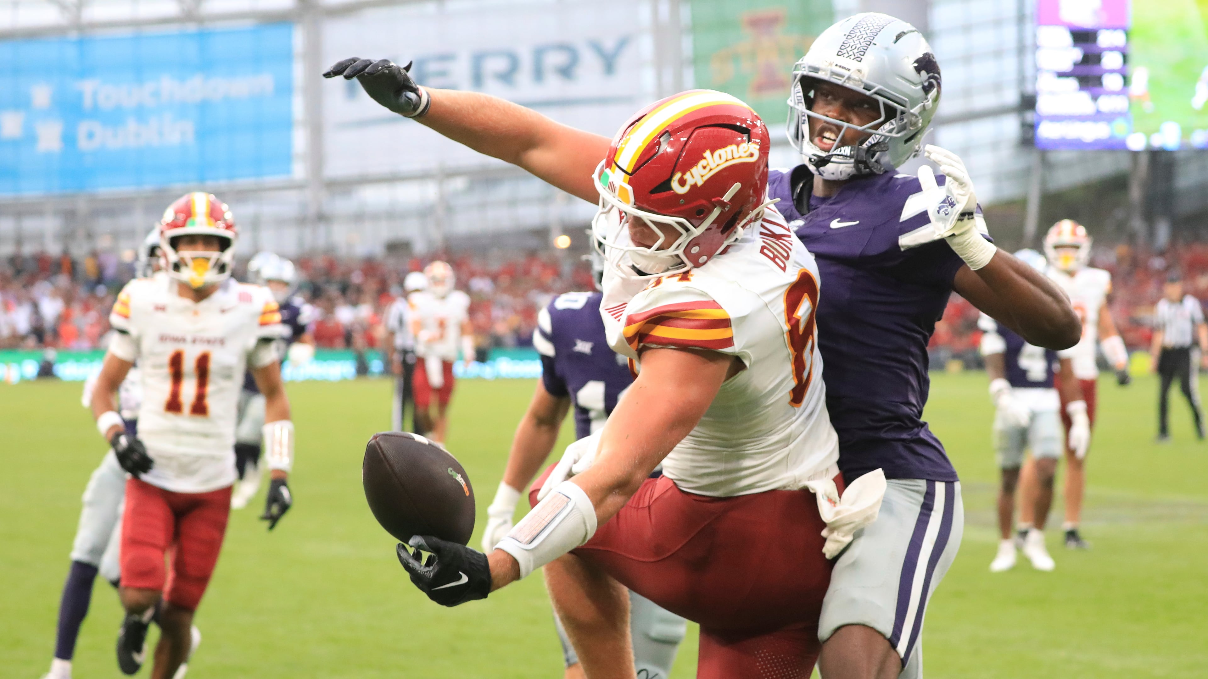 Iowa State Gabe Burkle, left, tries to catch the ball past Kansas State VJ Payne during an NCAA college football game between Iowa State and Kansas State in Dublin, Ireland Saturday, Aug. 23, 2025. (AP Photo/Peter Morrison)