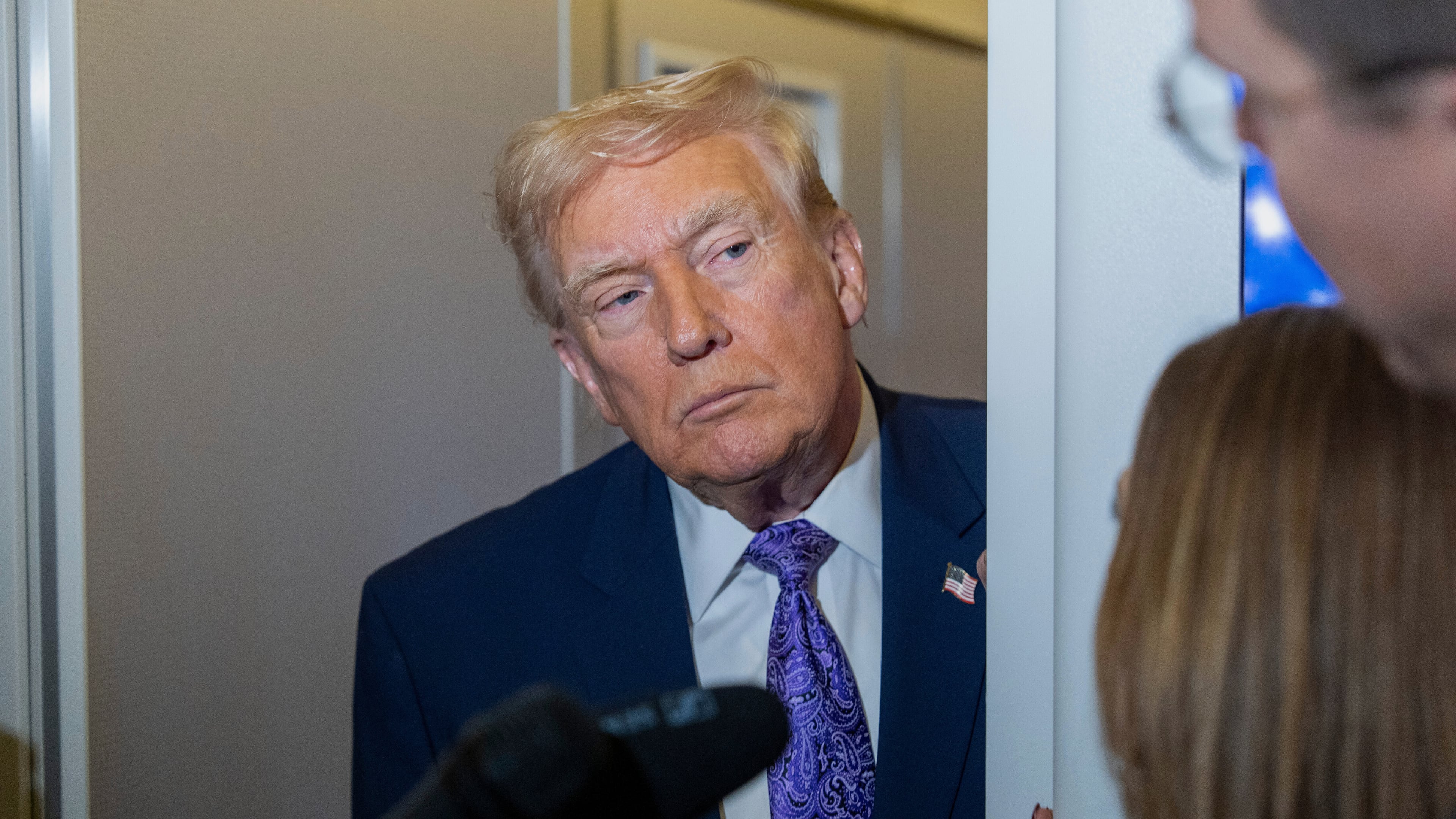 President Donald Trump speaks with reporters while in flight on Air Force One from his Mar-a-Lago estate in Palm Beach, Fla., to Joint Base Andrews, Sunday, Nov. 30, 2025. (AP Photo/Alex Brandon)