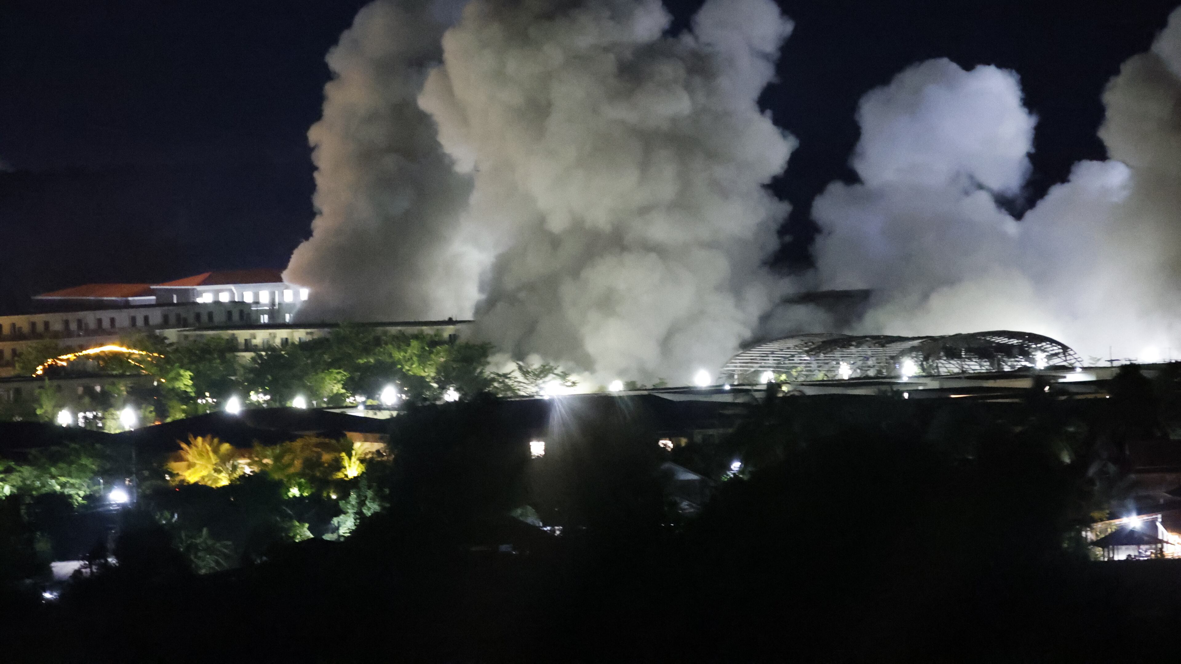 White smoke billows after an explosion at KK Park online scam center in Myawaddy township, Karen State, Myanmar, Saturday, Oct. 25, 2025. (AP Photo/Sarot Meksophawannakul)