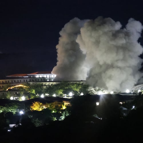 White smoke billows after an explosion at KK Park online scam center in Myawaddy township, Karen State, Myanmar, Saturday, Oct. 25, 2025. (AP Photo/Sarot Meksophawannakul)