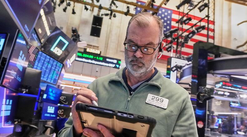 Trader William Lawrence works on the floor of the New York Stock Exchange, Monday, Jan. 26, 2026. (AP Photo/Richard Drew)
