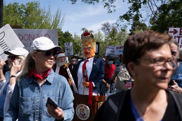 Demonstrators rally against President Donald Trump and Tesla CEO Elon Musk in San Jose, Calif., as part of a national day of action on Saturday, April 5, 2025. (AP Photo/Emily Steinberger)