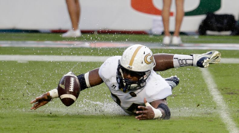 Georgia Tech running back Marcus Marshall recovers his own fumble during the second half of an NCAA college football game against Miami , Saturday, Nov. 21, 2015 in Miami Gardens, Fla. Miami defeated Georgia Tech 38-21. (AP Photo/Lynne Sladky)