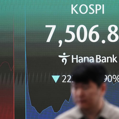 A dealer walks past a screen showing the Korea Composite Stock Price Index (KOSPI) at a dealing room of Hana Bank in Seoul, South Korea, Thursday, June 11, 2026. (AP Photo/Lee Jin-man)