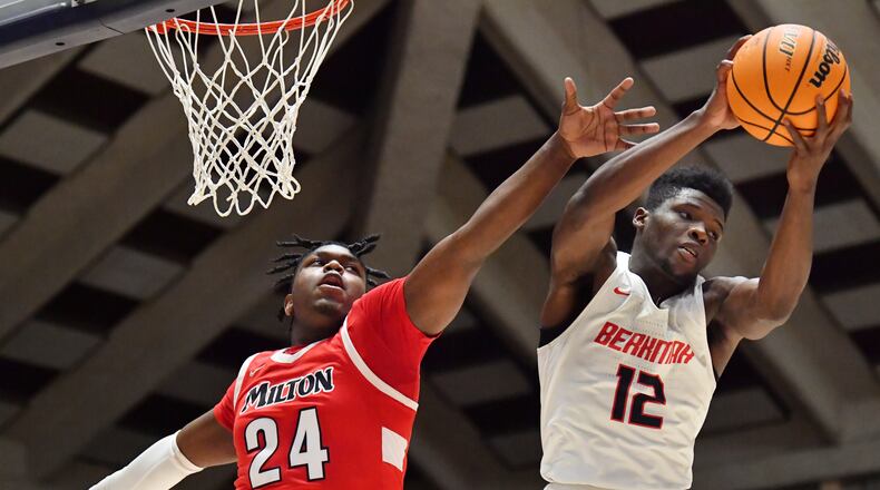 March 13, 2021 Macon - Berkmar's Dara Olonade (12) grabs a rebound over Milton's L.T. Overton (24) during the 2021 GHSA State Basketball Class AAAAAAA Boys Championship game at the Macon Centreplex in Macon on Saturday, March 13, 2021 Milton won 52-47 over Berkmar. (Hyosub Shin / Hyosub.Shin@ajc.com)