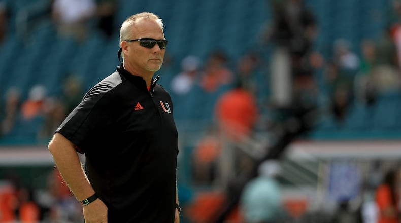 Miami's Mark Richt alone with his thoughts earlier this month vs. Virginia. (Mike Ehrmann/Getty Images)