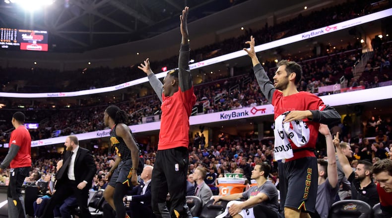 Dennis Schroder and Jose Calderon of the Atlanta Hawks celebrate after a teammate scored during the second half against the Cleveland Cavaliers at Quicken Loans Arena on April 7, 2017 in Cleveland, Ohio. The Hawks defeated the Cavaliers 114-100. (Photo by Jason Miller/Getty Images)