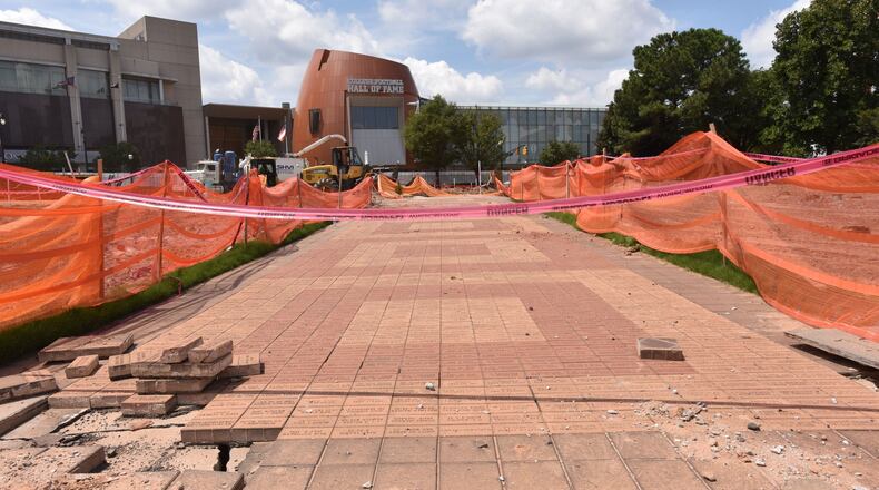 Engraved Olympic bricks will be preserved at Centennial Olympic Park, where workers are creating more greenspace and open sightlines. HYOSUB SHIN / HSHIN@AJC.COM