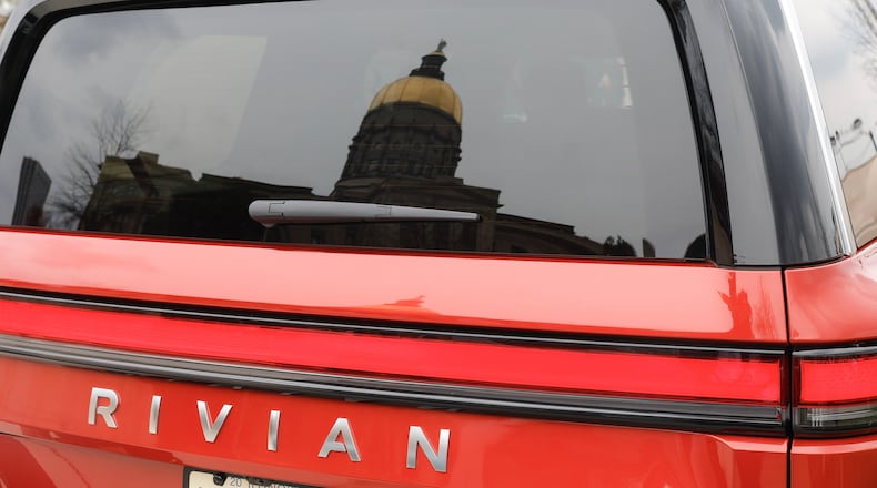 Views of the Georgia State Capitol reflected in the window of a Rivian electric vehicle on Wednesday, March 1, 2023. (Natrice Miller/The Atlanta Journal-Constitution/TNS)