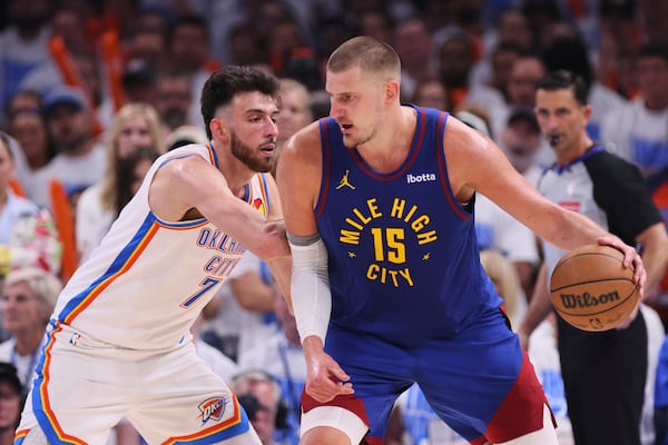 Denver Nuggets' Nikola Jokic (15) works to the basket against Oklahoma City Thunder's Chet Holmgren, left, in the second half of Game 5 of an NBA basketball second-round playoff series Tuesday, May 13, 2025, in Oklahoma City. (AP Photo/Nate Billings)