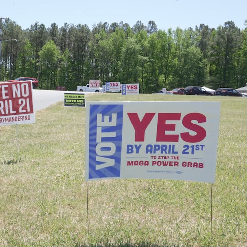 FILE - A truck passes political signs outside a polling place at Good Shepherd Catholic Church in South Hill, Va., on Tuesday, April 21, 2026. (AP Photo/Allen G. Breed)