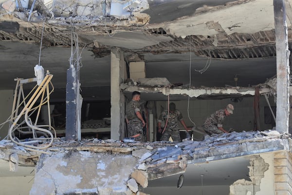 Lebanese army soldiers inspect a destroyed house that was hit in an Israeli airstrike in Nabatieh town, south Lebanon, Friday, June 27, 2025. (AP Photo/Mohammed Zaatari)