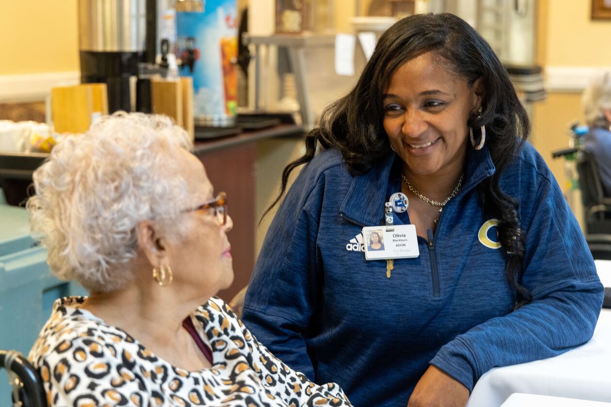 Assistant Director of Nursing Olivia Blackburn chats with resident Ethel Williams during lunch at the A.G. Rhodes Wesley Woods facility in Decatur.  PHIL SKINNER FOR THE ATLANTA JOURNAL-CONSTITUTION