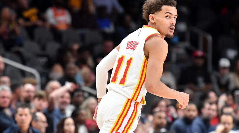 March 31, 2022 Atlanta - Atlanta Hawks' guard Trae Young (11) reacts after scoring during the first half in an NBA basketball game at State Farm Arena on Thursday, March 31, 2022. Atlanta Hawks won 131-107 over Cleveland Cavaliers. (Hyosub Shin / Hyosub.Shin@ajc.com)