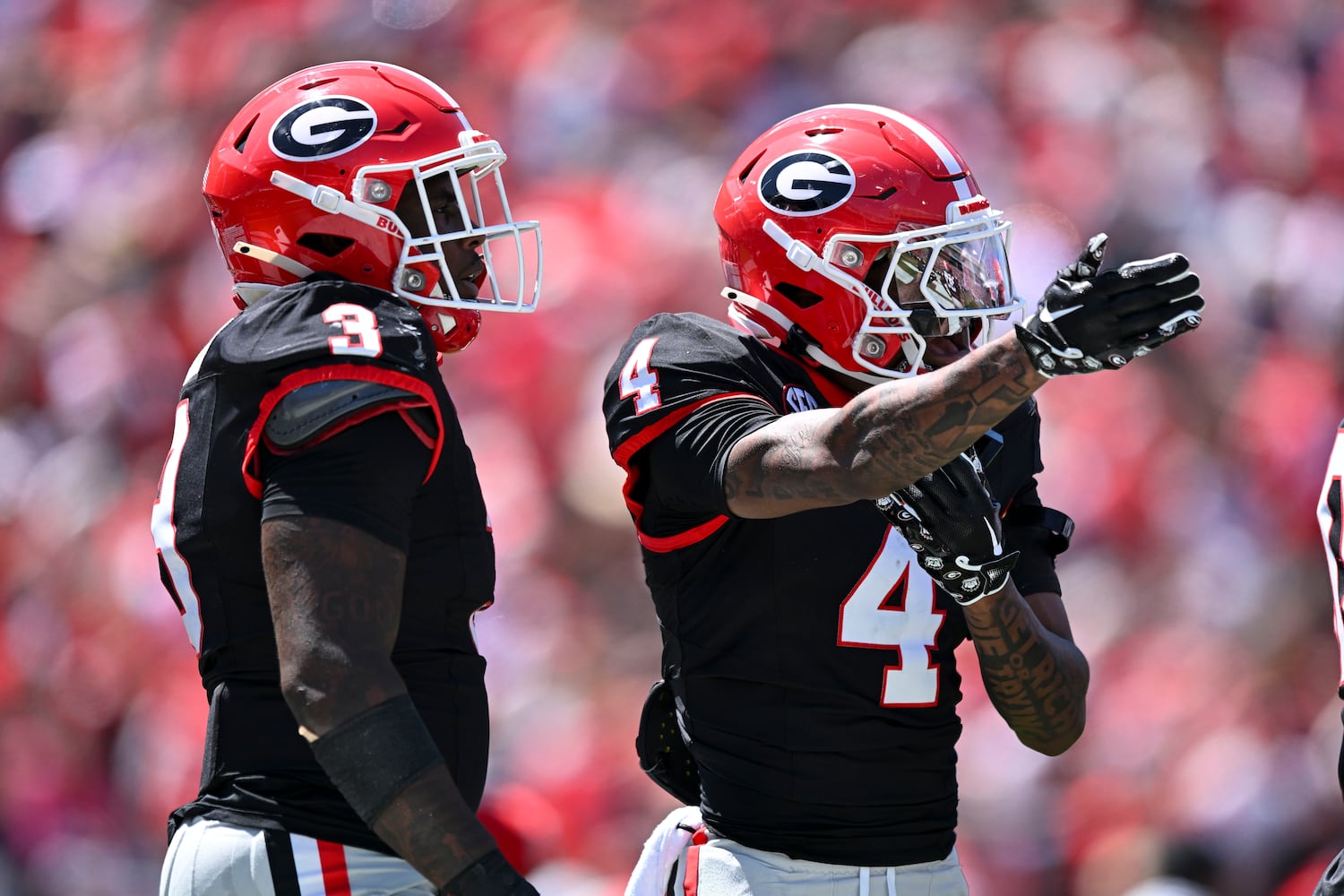 Georgia Black Team’s KJ Bolden (4) reacts to a referee’s call as CJ Allen (3) looks on during the first half of the G-Day spring football game Saturday, April 12, 2025 at Sanford Stadium in Athens. (Daniel Varnado/For the Atlanta Journal-Constitution)