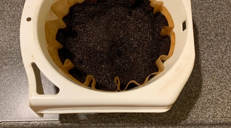 Coffee grounds are easy to scatter around garden plants each day. They are not problematic in any way. (Walter Reeves for The Atlanta Journal-Constitution)