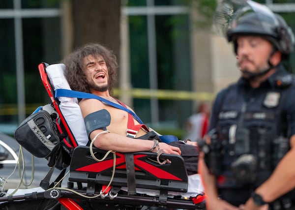 Arturo Gamboa is taken away in handcuffs on a gurney during the “No Kings” protest in Salt Lake City on Saturday, June 14, 2025. (Scott G. Winterton/The Deseret News via AP)
