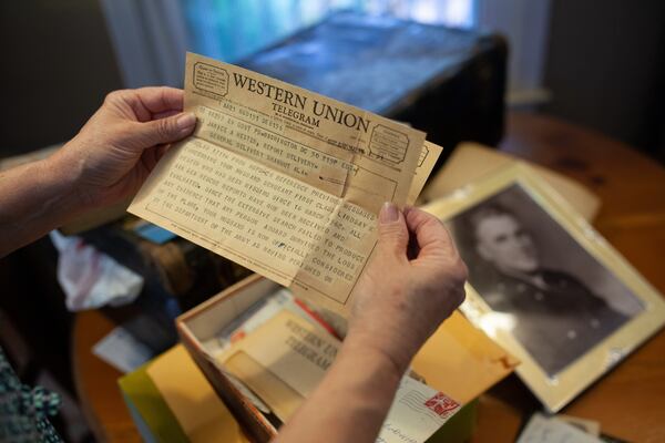Jan Stephens holds a Western Union telegram sent to her mother in 1962 about the disappearance of Sgt. 1st Class Lindsay Hester. (BRANDEN CAMP FOR THE ATLANTA JOURNAL-CONSTITUTION)