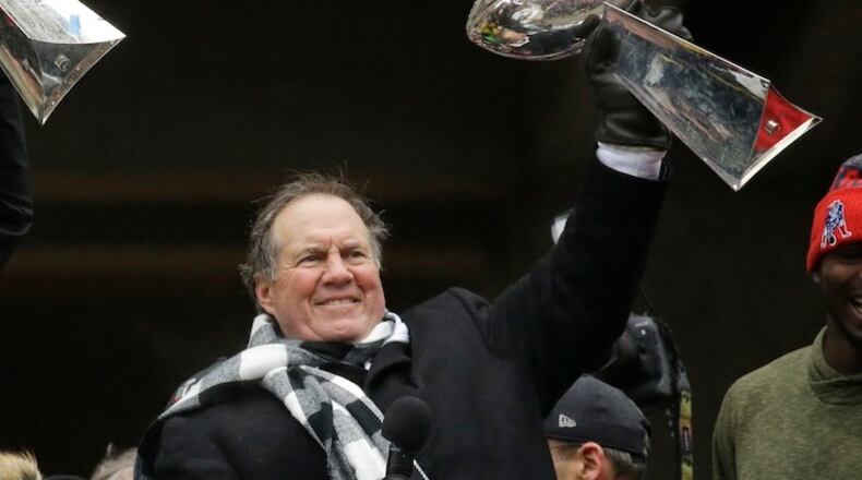 In this Feb. 7, 2017, file photo, New England Patriots coach Bill Belichick holds up a Super Bowl trophy as he addresses the crowd during a rally in Boston, to celebrate the team's 34-28 win over the Atlanta Falcons in the NFL Super Bowl 51 football game in Houston. Belichick's unmatched 18-year tenure in New England made him the runaway winner in voting as the NFL's top coach by an Associated Press panel released Friday, Dec. 29, 2017 Belichick received 10 of the 11 first-place votes and 105 of a possible 110 points from a panel of Hall of Fame receiver James Lofton and 10 AP football writers. (AP Photo/Elise Amendola, File)