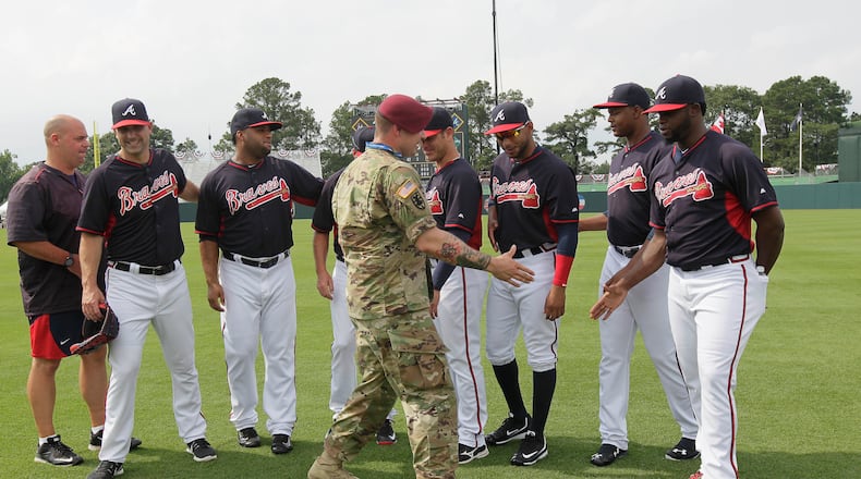 U.S. Army Sgt. Alex Burnett of the 82nd Airborne Division greets Atlanta Braves players prior to their game against Miami at Fort Bragg, N.C. (AP Photo/Gerry Broome)