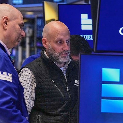 Specialists Philip Finale, left, and Meric Greenbaum work on the floor of the New York Stock Exchange, Friday, May 29, 2026. (AP Photo/Richard Drew)