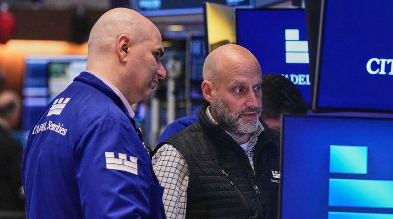 Specialists Philip Finale, left, and Meric Greenbaum work on the floor of the New York Stock Exchange, Friday, May 29, 2026. (AP Photo/Richard Drew)