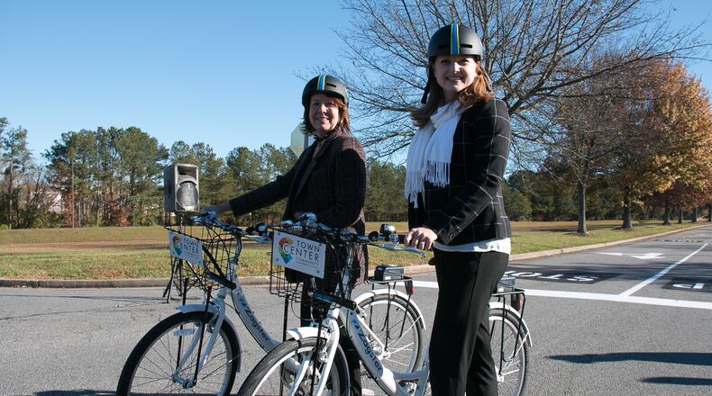 Faye DiMassimo, (left) the director of the Cobb County Department of Transportation, and Tracy Rathbone, (right) executive director of Town Center Community Improvement District pose with new Zagster bike share bicycles on Friday, Nov. 20, 2015. Photo courtesy of Town Center CID.