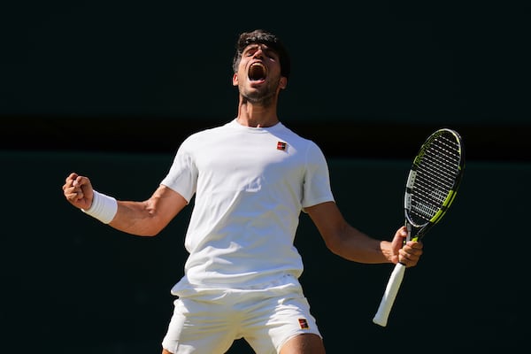 Carlos Alcaraz of Spain celebrates winning the men's semifinal singles match against Taylor Fritz of the U.S. at the Wimbledon Tennis Championships in London, Friday, July 11, 2025.(AP Photo/Kirsty Wigglesworth)