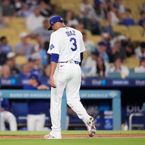 Los Angeles Dodgers pitcher Edwin Díaz walks off the field after being taken out of the game during the ninth inning of a baseball game against the Milwaukee Brewers, Thursday, Aug. 13, 2026, in Los Angeles. (AP Photo/Mark J. Terrill)